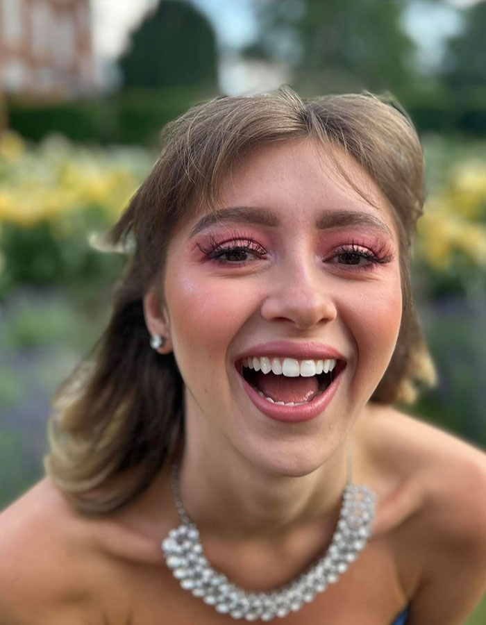 Young woman smiling outdoors, representing anti-vax mom of Cambridge 23-year-old graduate who passed away from cancer. Young woman smiling outdoors, representing anti-vax mom of Cambridge 23-year-old graduate who passed away from cancer.