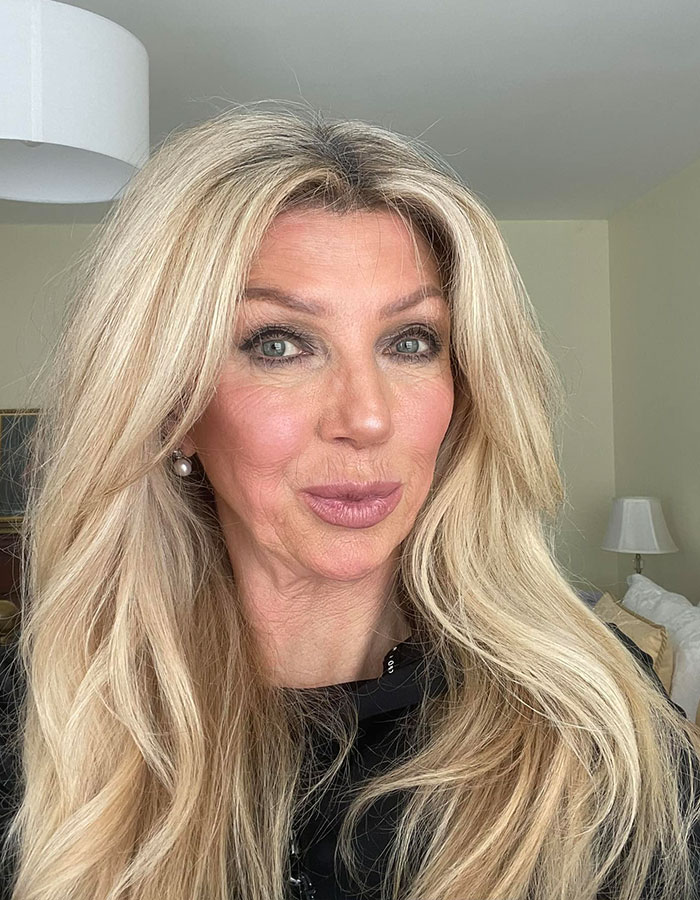 Blonde woman with long hair in a room, representing anti-vax mom of Cambridge graduate who passed away of cancer. Blonde woman with long hair in a room, representing anti-vax mom of Cambridge graduate who passed away of cancer.