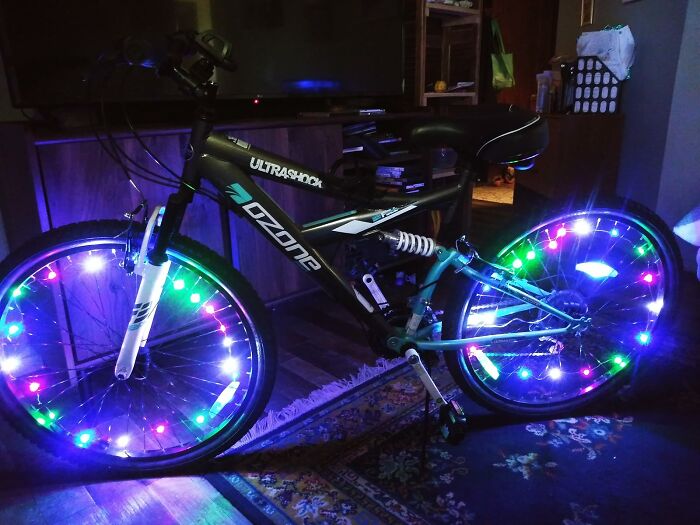 Black Ozone Ultrashock bike with colorful LED lights on wheels, perfect gift idea for shopping for a 12-year-old child