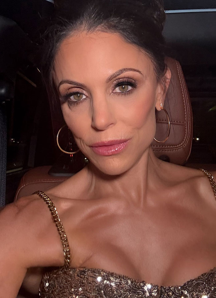 Bethenny Frankel showing stunning results of supermodel diet, wearing a glamorous sequined top with hoop earrings.