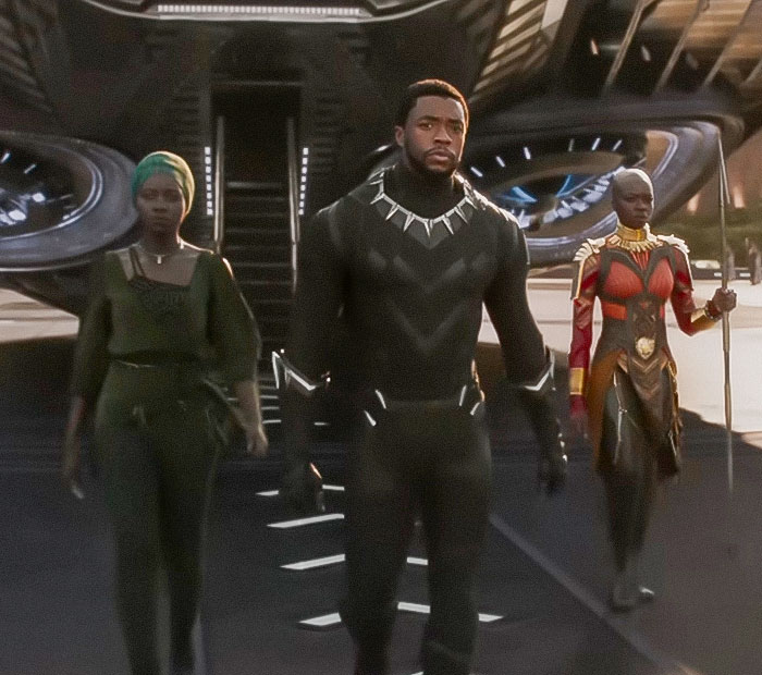 Black Panther and two allies walking confidently in futuristic setting, highlighting Marvel's new Black Panther character reveal.