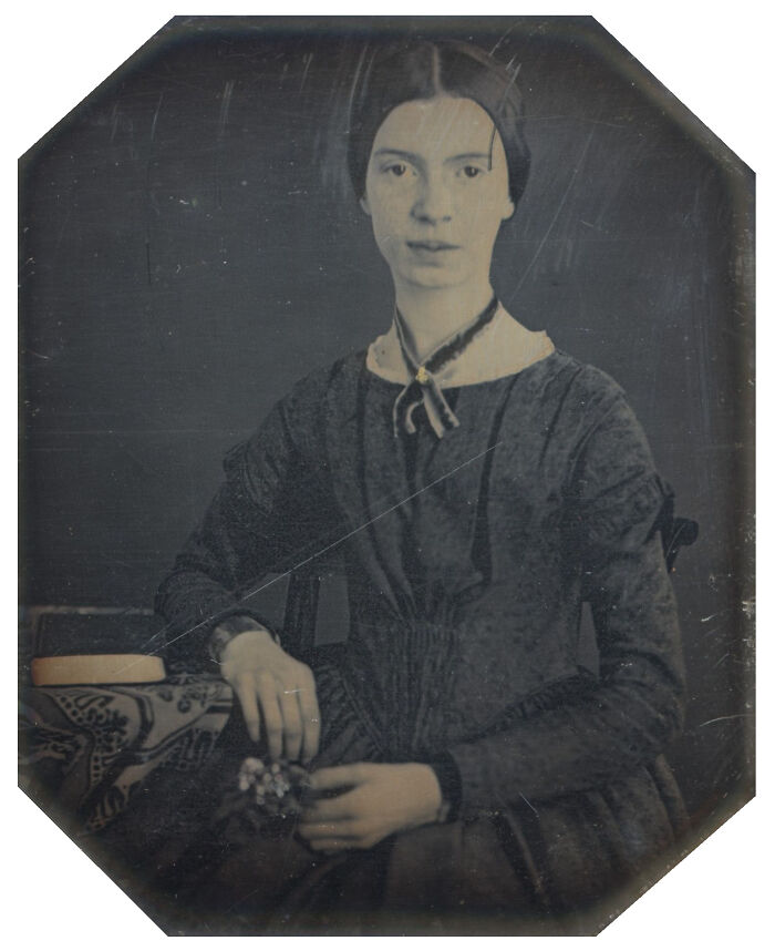 Victorian woman seated holding flowers in a historic portrait style reflecting Nikola Tesla era influences.