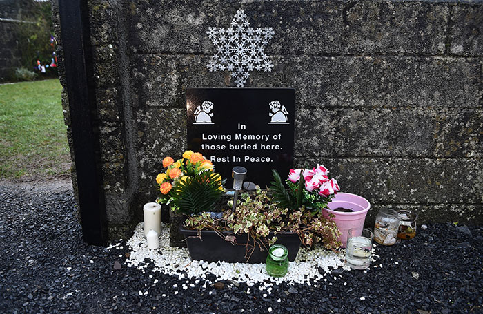 Memorial site with flowers and candles honoring babies' bodies expected to be found at Catholic home septic tank. Memorial site with flowers and candles honoring babies' bodies expected to be found at Catholic home septic tank.
