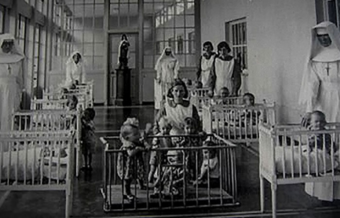 Black and white photo of babies and nuns inside a Catholic home for unwed mothers, related to babies' bodies septic tank case. Black and white photo of babies and nuns inside a Catholic home for unwed mothers, related to babies' bodies septic tank case.