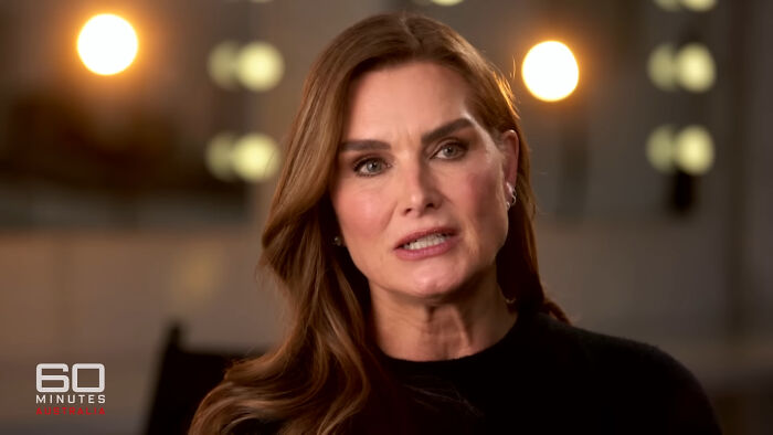 Close-up of a woman speaking in a 60 Minutes Australia interview highlighting Hollywood hypocrisy on aging.