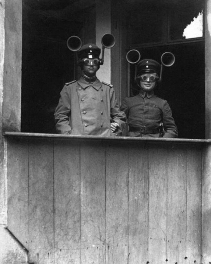 Two historical figures wearing mysterious ear and eye gear, creating a confusing scene in vintage history pics.