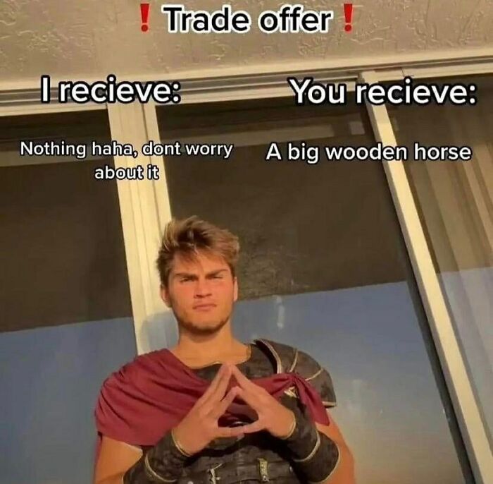 Young man dressed as a Roman soldier posing with a trade offer meme about a big wooden horse, history memes concept.