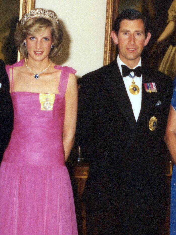 Princess Diana in a pink gown and tiara standing next to a man in formal attire, highlighting royal facts about Princess Diana.