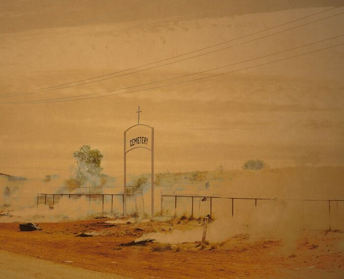 Desert cemetery scene with dusty atmosphere showcasing stunning color photography winners from the 1839 awards.