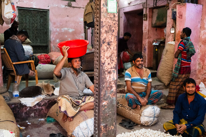 Group of men in a rustic indoor market capturing candid street moments full of emotion by a photographer traveling the world