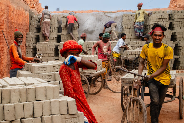 Workers at a brick factory captured in a candid street moment full of emotion by a traveling photographer.