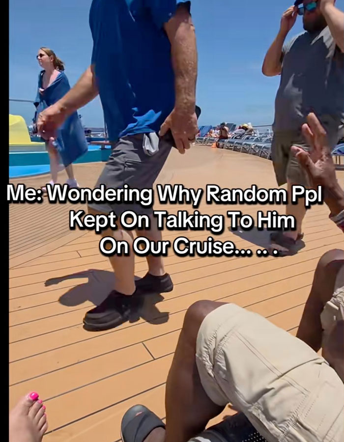 Cruise passenger on deck confused by attention while wearing casual clothes on a sunny day outside.