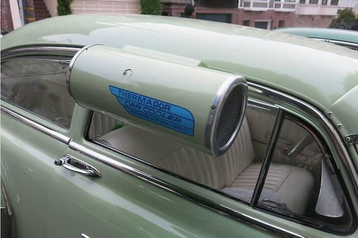Vintage car with an old Thermador cap cooler mounted on the partially open window, showcasing historical automotive accessories.