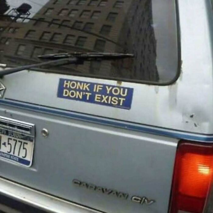 Bumper sticker on a gray vehicle reading honk if you don't exist, a meme designed to make intellectuals chuckle.