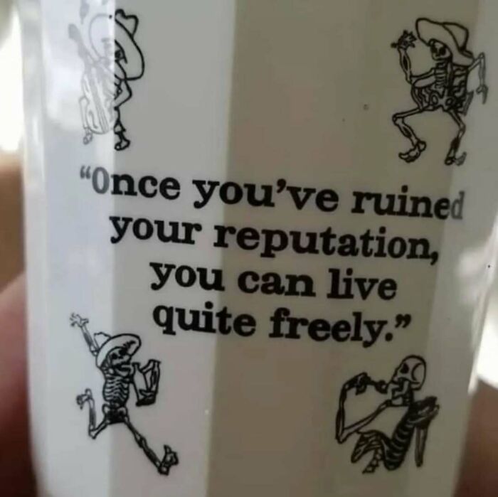 Mug with skeleton illustrations and a quote about living freely after ruining your reputation, intellectual memes humor.