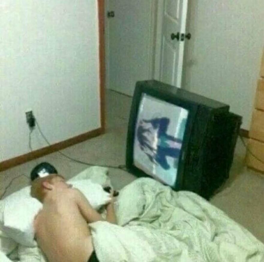 Child lying on the floor watching a distorted image on an old TV, a bizarre yet hilarious pic causing a double take.