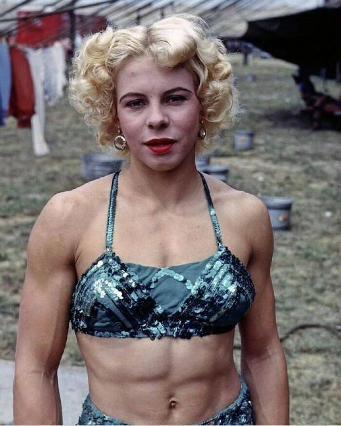 Vintage photo of a muscular woman in a sequin top, illustrating weird things about history in a unique Instagram account.