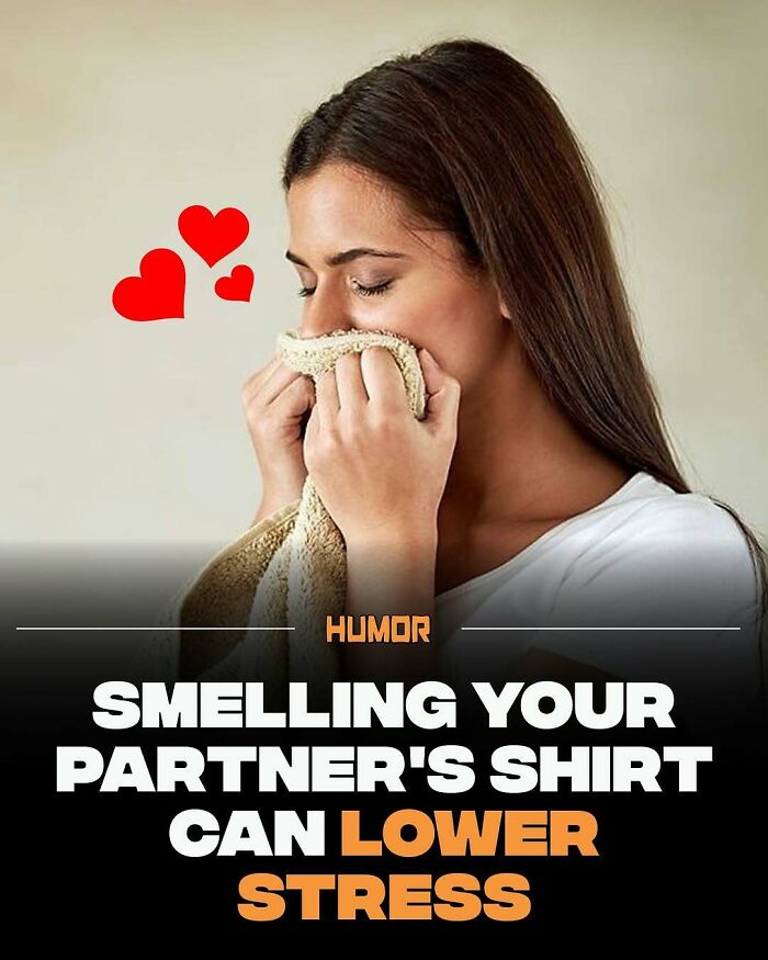 Woman smelling a partner's shirt with hearts, illustrating a fact to help satiate brain cravings for new knowledge.