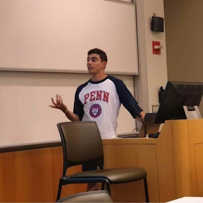 Young man giving a lecture in a classroom setting, discussing topics related to nature, animals, and random fun facts.