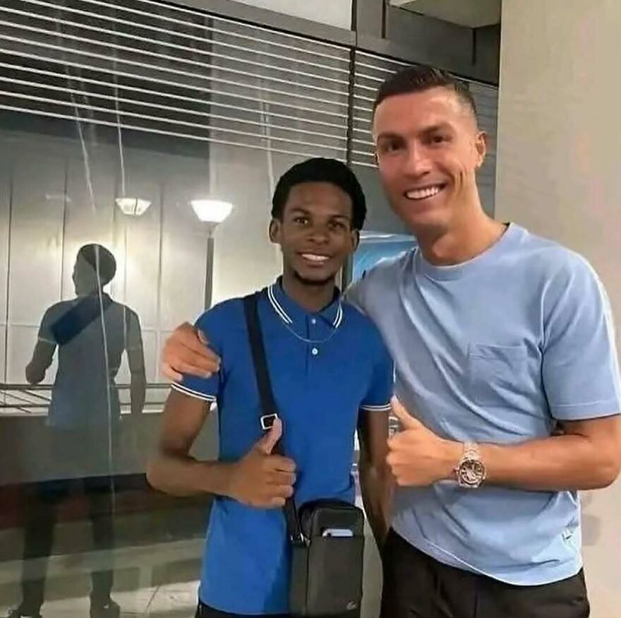 Two men posing indoors with thumbs up, a bizarre yet hilarious pic that might make you do a double take.