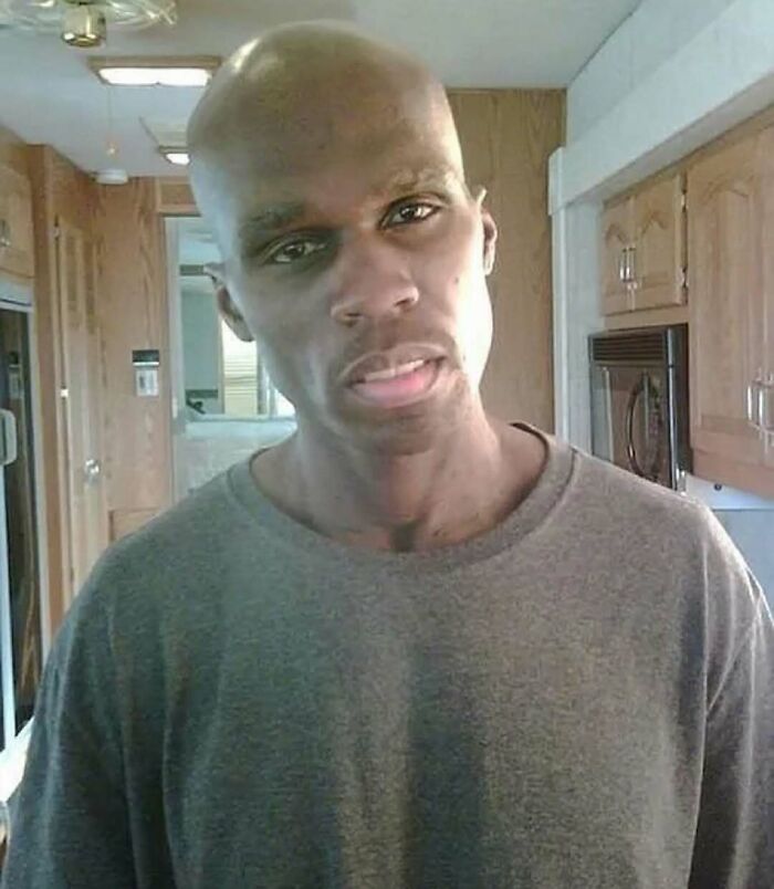 Man with unusual facial features standing inside a wooden kitchen, illustrating bizarre nature and animal-related fun facts.