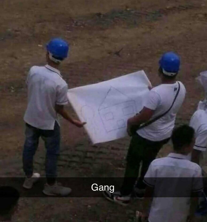 Two construction workers in blue helmets holding a simple house drawing, a bizarre yet hilarious pic that makes you do a double take.