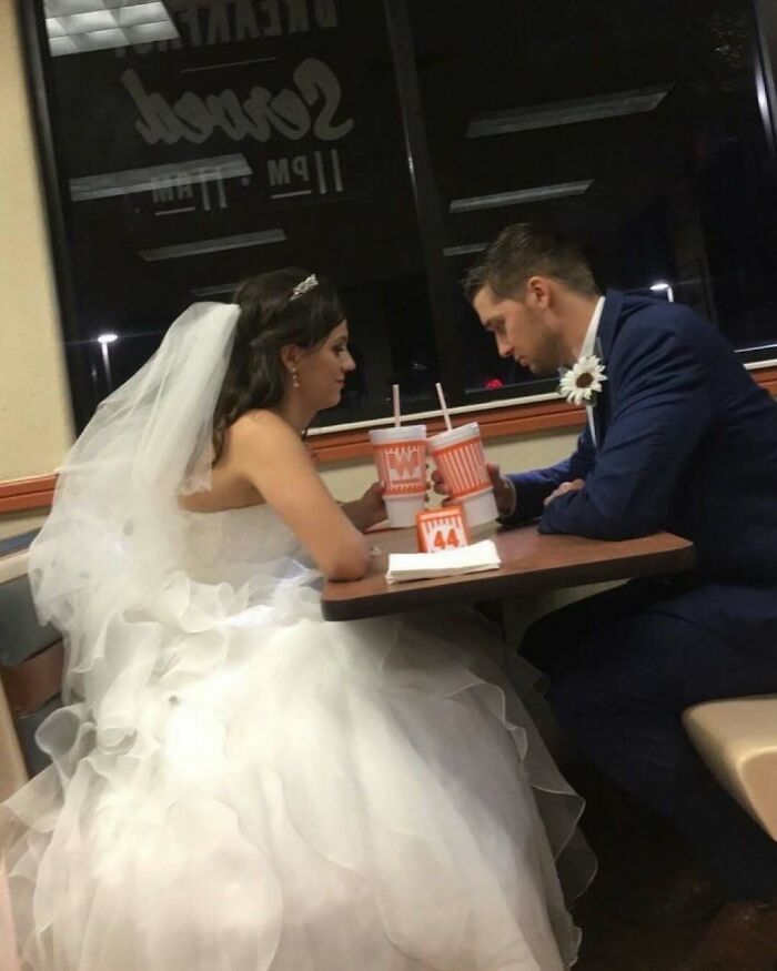 Bride and groom in wedding attire sharing drinks at fast food restaurant, a bizarre scene in nature and animals fun facts context