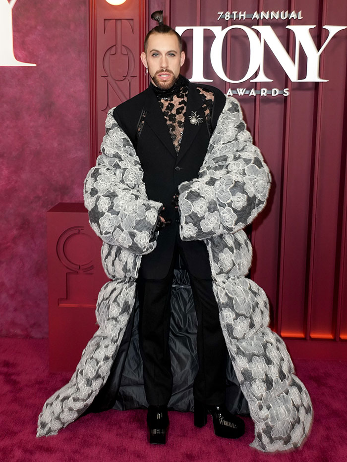 Man wearing a floral oversized coat and black suit posing at the 2025 Tony Awards worst dressed stars red carpet event.