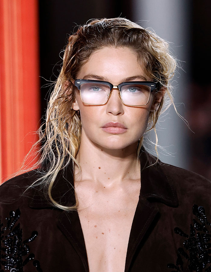 Model with depression hairstyle and glasses showcasing the latest trend adopted by Gen Z, sparking millennials' reactions.