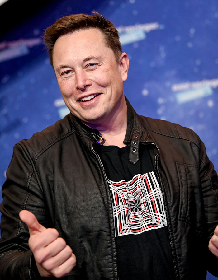 Elon Musk smiling and giving thumbs up in a black jacket, showing signs of sudden aging after feud with Donald Trump.
