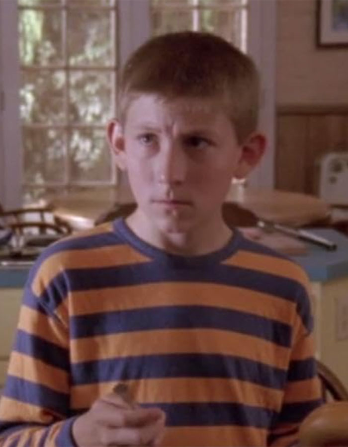 Young boy wearing a striped shirt in a kitchen setting, related to Bryan Cranston discussing Dewey in Malcolm In The Middle. Young boy wearing a striped shirt in a kitchen setting, related to Bryan Cranston discussing Dewey in Malcolm In The Middle.