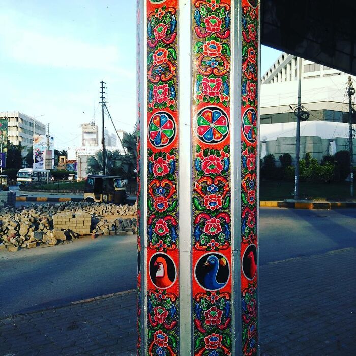Intricate colorful patterns painted on a street pillar, showcasing the artist’s skill in transforming urban surfaces into art.