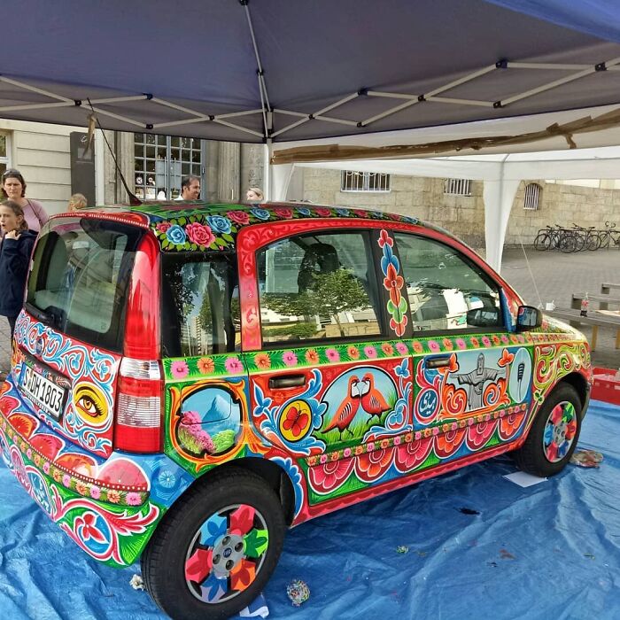 Car transformed into stunning works of art with colorful, intricate patterns showcasing detailed floral and animal designs.