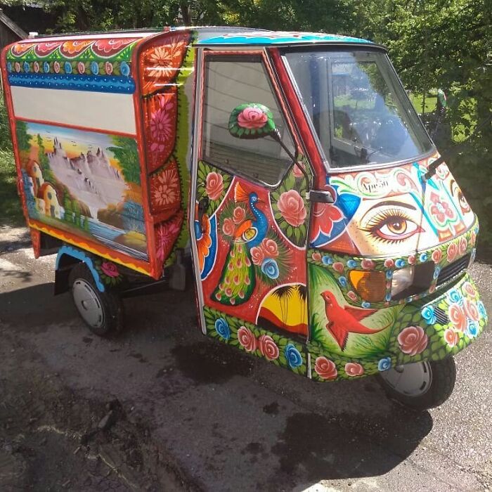Colorful, intricate patterns decorate a small vehicle, turning it into a stunning work of art with vibrant designs and detailed illustrations.