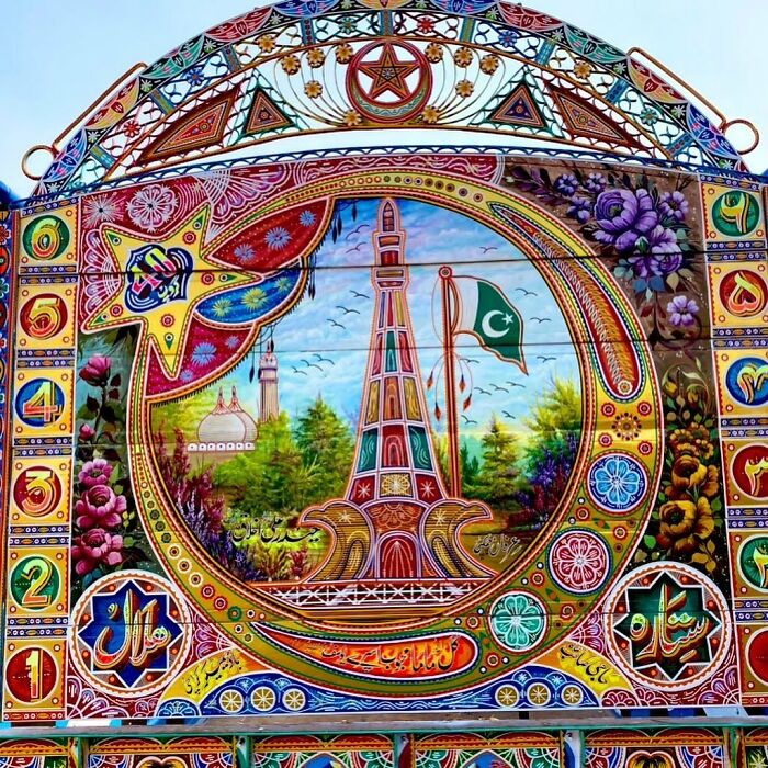 Colorful, intricate patterns decorate a car panel featuring a detailed artistic design with cultural and floral motifs.
