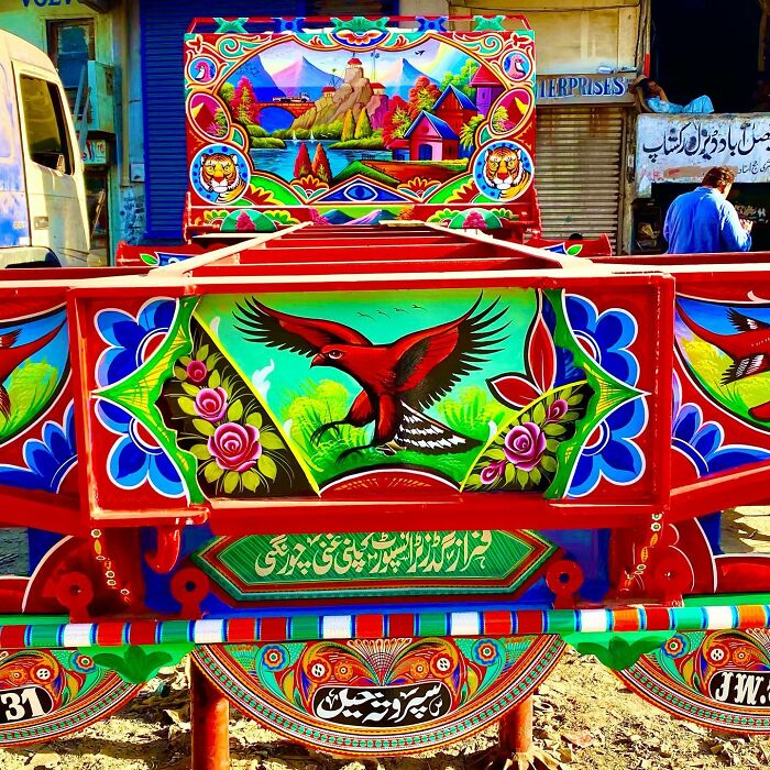 Colorful, intricate patterns decorating a truck with detailed bird and floral artwork in vibrant hues.