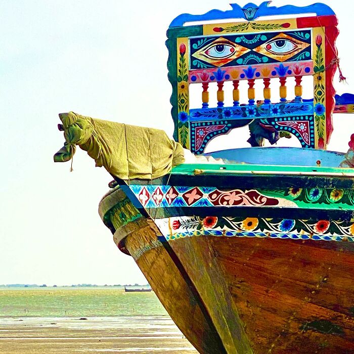 Colorful and intricate patterns painted on a traditional wooden boat, showcasing stunning artistic work and vibrant designs.