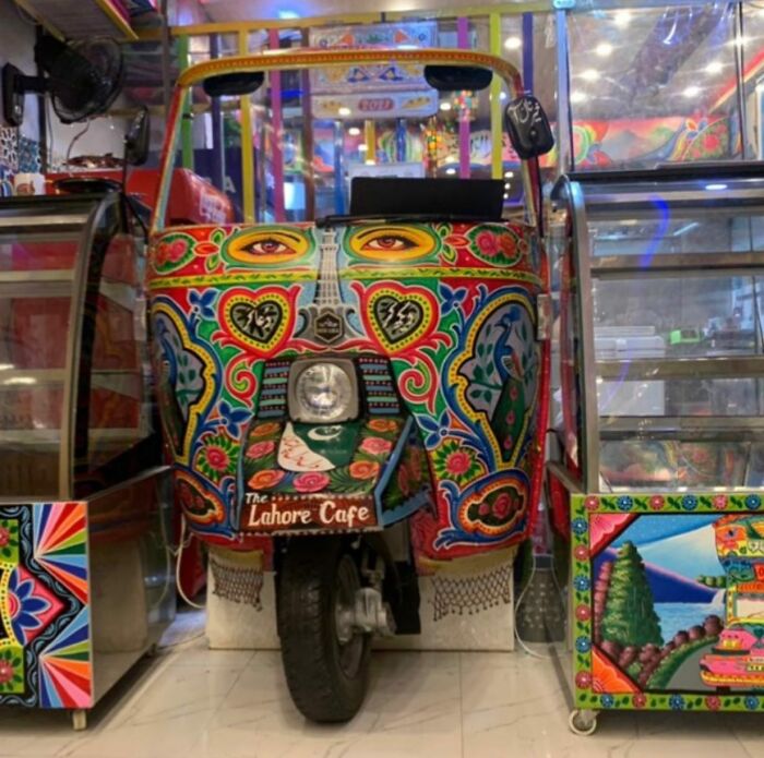 Colorful and intricate patterns painted on a rickshaw showcasing stunning works of art on vehicles.