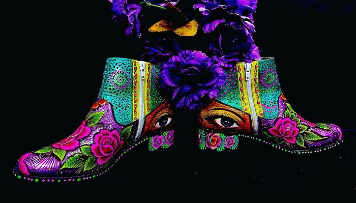 Colorful artistically painted shoes with intricate patterns and eye designs, showcasing stunning works of art.