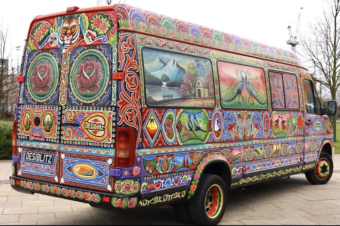 Van covered in colorful, intricate patterns transforming a car into a stunning work of art outdoors.