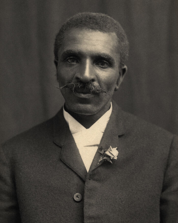 Black inventor with mustache wearing a suit, representing world-changing inventions by people of color in history.