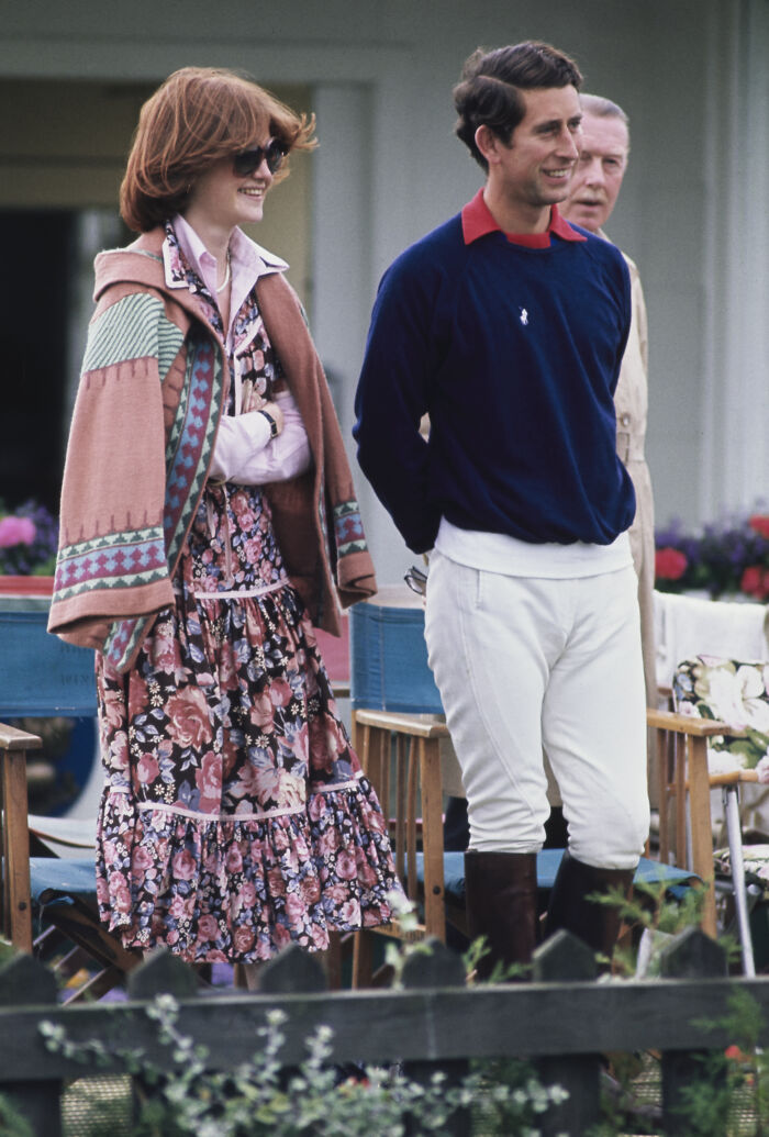 Princess Diana and Prince Charles casually dressed at an outdoor event, showcasing early royal fashion and style.