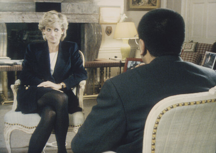 Princess Diana seated during an interview in a formal room, showcasing intriguing moments of the royal family history.