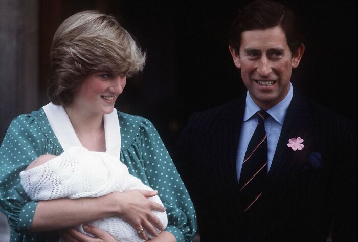 Princess Diana holding a newborn baby smiling next to Prince Charles, capturing rare royal family moments and fascinating facts.