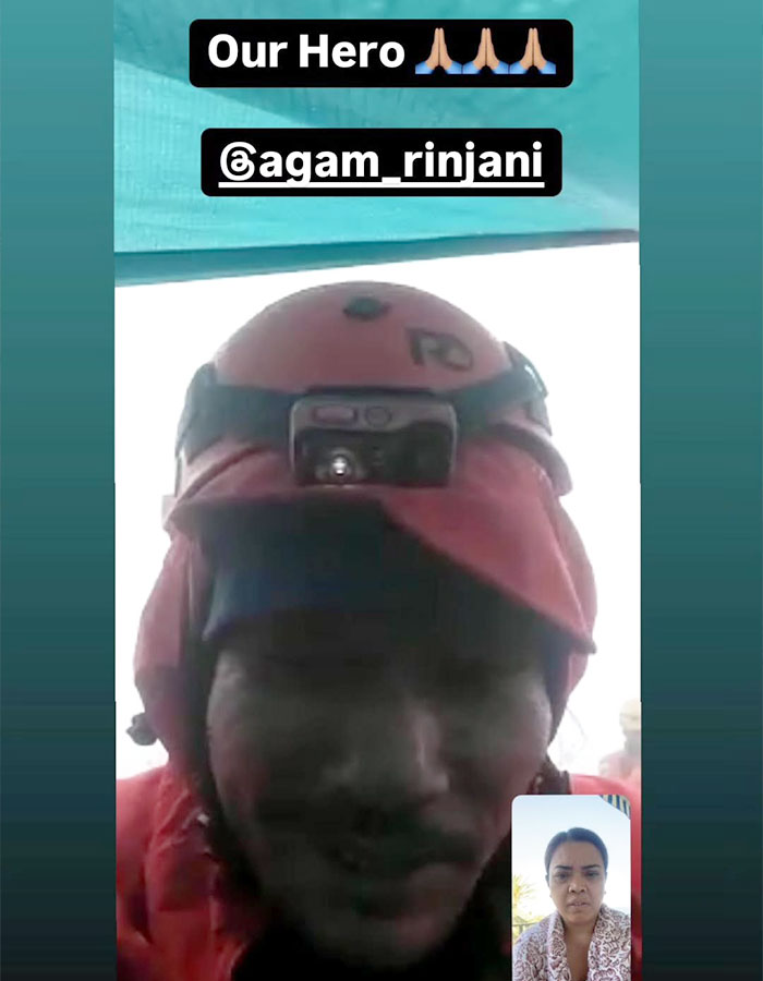 Rescue guide in helmet recovering tourist's body from 1600ft-deep active volcano during video call.