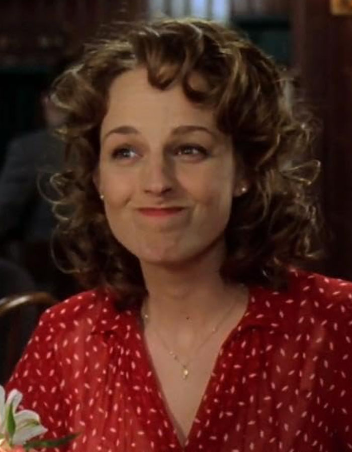 Helen Hunt smiling with curly hair, wearing a red patterned blouse, embracing perfectly imperfect beauty standards. Helen Hunt smiling with curly hair, wearing a red patterned blouse, embracing perfectly imperfect beauty standards.