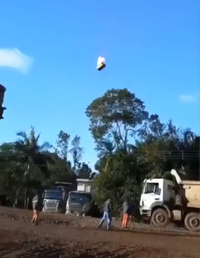 Burning hot air balloon basket falling from the sky in Brazil as people on the ground watch during emergency landing. Burning hot air balloon basket falling from the sky in Brazil as people on the ground watch during emergency landing.