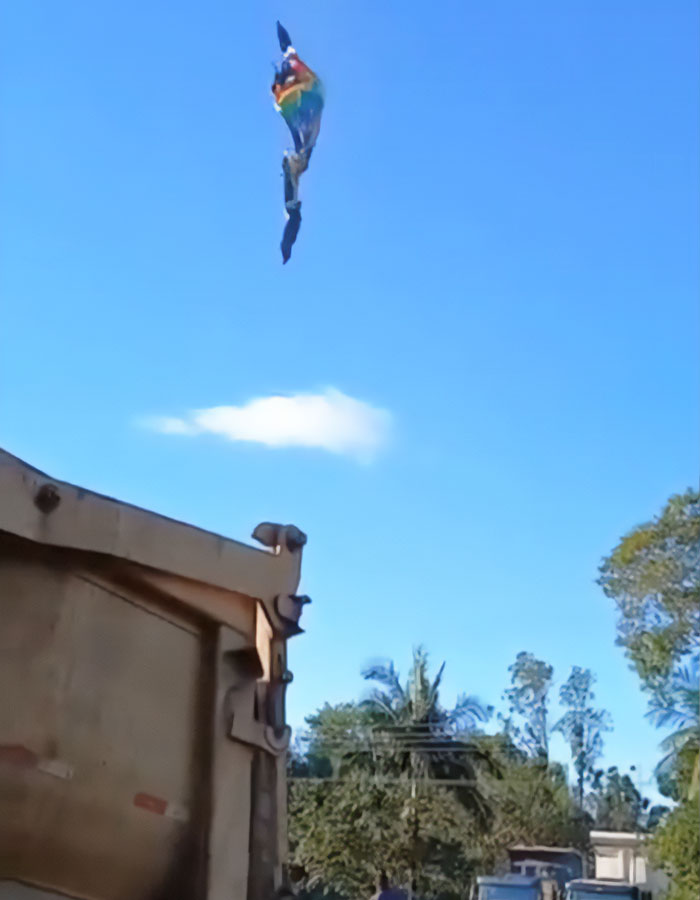Burning hot air balloon in Brazil with passengers falling from the sky amid an emergency escape situation. Burning hot air balloon in Brazil with passengers falling from the sky amid an emergency escape situation.