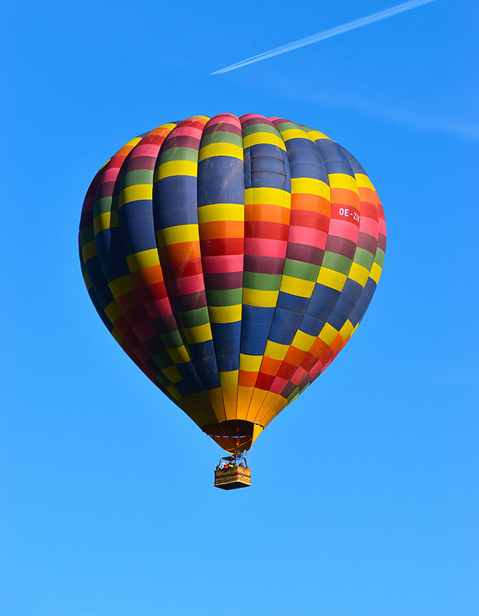 Colorful hot air balloon flying against clear blue sky before reported burning incident in Brazil carrying 20 passengers. Colorful hot air balloon flying against clear blue sky before reported burning incident in Brazil carrying 20 passengers.