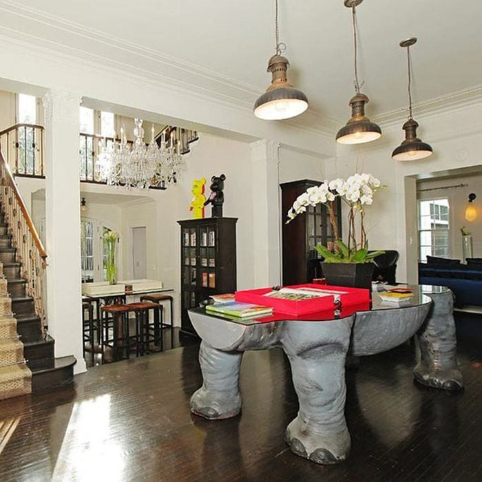 Unique real estate listing interior featuring an elephant-legged table and eclectic decor in a spacious home.